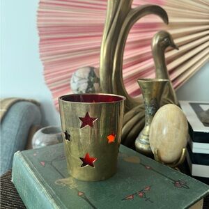 Vintage brass tea light candle holder with red glass lining.